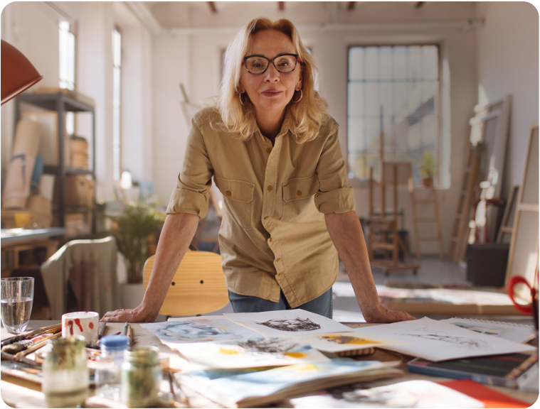 Suzy at work, standing over her desk.